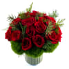 A modern winter holiday arrangement is designed with lush red roses accented