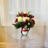 Send a little winter joy with this festive floral design arranged in