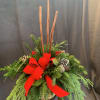 Birch vase filled with cinnamon sticks, mixed ever greens, cones and berries.