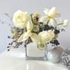 Sleek yet dreamy- whites, silvers and special touches in this arrangement. 