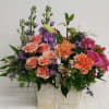 In this arrangement, variety of flowers including Rose. Spray Rose, Stock, Asiatic