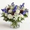 Inspired by winter&rsquo;s cool blue and white landscape, our arrangement delivers warm