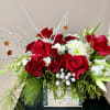 A small wooden boxes filled with red roses, carnations, stock, tulips, seasonal