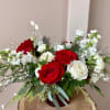 Cute, lovely, and joyous Holiday arrangement designed with fresh white and red