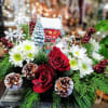 A festive keepsake cottage accented with holiday greens and flowers.