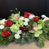 Centerpiece of evergreens with premium flowers, including roses, orchids and calla lily
