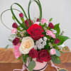 Unique and sweet arrangement made of reds, whites, and pinks with fresh