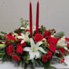 Traditional long and low centerpiece, includes red carnations, red mini carnations ad