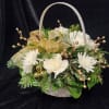 A beautiful winter arrangement in a nice white basket.