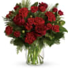 Surprise someone special this season! Radiant crimson flowers pop against a lush