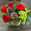 A Christmas beauty of fresh holiday greens with Christmas red flowers sprinkle