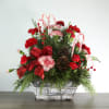 Get in the holiday spirit with this festive centerpiece! This arrangement includes