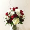 Beautiful assortment of fresh blooms, beautifully designed with a holiday flair. 