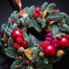 Holiday Wreath with Christmas decorations in red colors