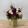 A combination of fall color flowers like ranunculus, chrysanthemum, and rose, in