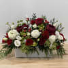 A combination of peonies, ranunculus, cymbidium orchids and roses, in a white