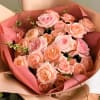 A combination of soft toned garden peach and pink roses fresh flowers.