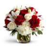 A decadent mix of creamy roses, bold red carnations, and snowy hydrangeas&mdash;this