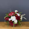 Bring holiday cheer to your home this winter season! This arrangement comes