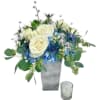 Lush blue hydrangea sits atop a frosted resin vase, paved with white
