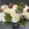 A perfect Christmas combo with roses, hydrangea, mixed seasonal greens and pine