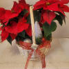 A beautiful dish garden filled with festive poinsettias and faux embellishments. Add