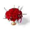 Red Elegance features a beautiful cluster of red roses arranged on a