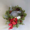This magical wreath is made with holiday greenery and silver accents. Everything