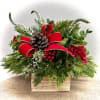 Assortment of Christmas evergreens and florals in a rustic wooden box 