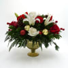Includes white and red roses, lilies, carnations, pinecones, Christmas ornaments, and Pine
