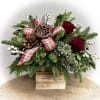 Mixed holiday greens, red roses, berries, Christmas balls, pine cones and beautiful