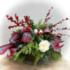 Assortment of winter greens, berries, Christmas balls, pine cones and roses adorned