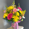 A beautiful and unique floral arrangement with seasonal fresh flowers. 