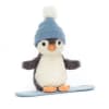 Cute plush penguin on a snowboard.