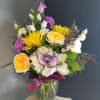 A beautiful one-of-a-kind arrangement made with fresh seasonal flowers. 