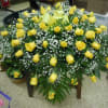 Extended length casket spray - 

A mixture of yellow roses,  greens