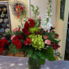 Seasonal flowers and assorted winter greens are designed in a compact container.
Accented