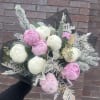 Flowers: 10 pink and white peonies with winter greenery accents 