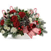 A Christmas classic, this arrangement bursts with festive blooms, fresh winter greens