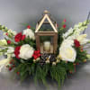 A beautiful Holiday centerpiece featuring a gold keepsake lantern. White roses, white