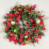 A traditional holiday wreath with beautiful red and green ornaments and a