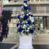 Beautiful Christmas tree made in blue and white colors with preserved roses