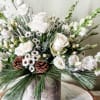 All white florals and mix of fresh cut winter greens in a