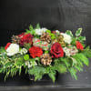 This beautiful centerpiece is traditional Christmas style with red and white flowers