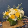 Yellow roses, blue hydrangea and cheerful gerber daisies make up the perfect
