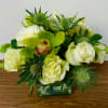 In a glas vase combinations of orchids, roses, helleborus, supernova