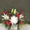 A white with red accents holiday forward bouquet with a variety of