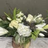 All white blooms accented with dark privet berries. Large Oriental lilies and