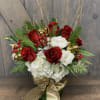 This Elegant display includes, Roses, Hydrangea, Coffee Berry, Christmas Greens, Silver and