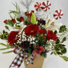 Very unique holiday flower arrangement with gerbera daisies, spray roses, lilies, greenery
